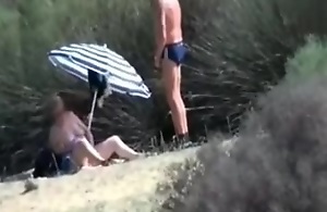 Pervert granny masturbates at the of stranger at beach