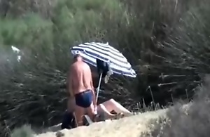 Pervert granny masturbates in front be advantageous to stranger at littoral